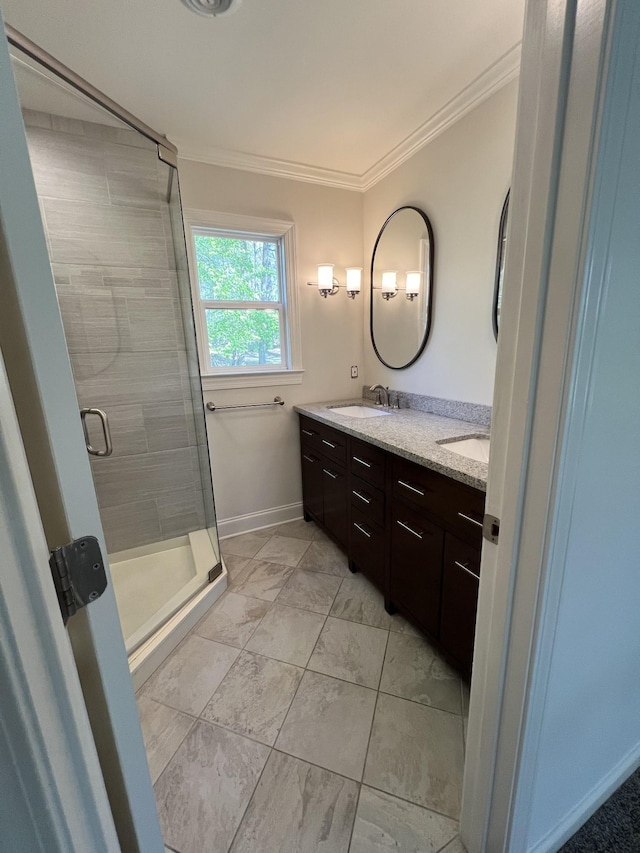 full bath featuring baseboards, a sink, ornamental molding, double vanity, and a stall shower