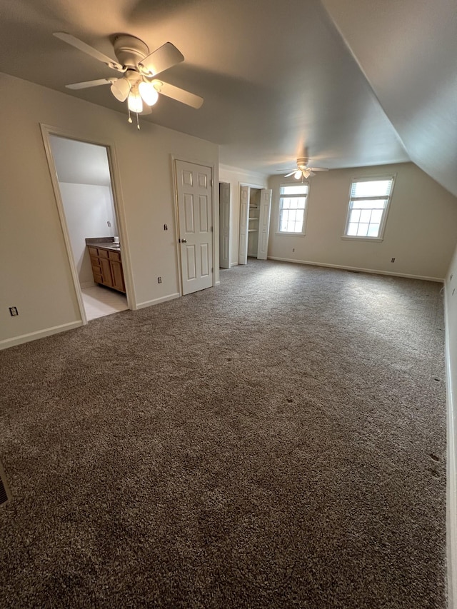 interior space featuring baseboards and a ceiling fan