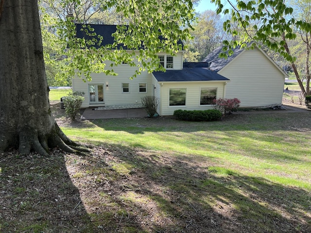 back of house featuring french doors, a patio, and a yard