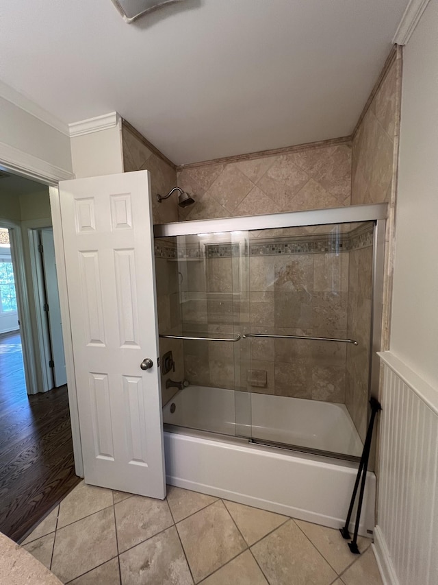 bathroom featuring crown molding, tile patterned flooring, and bath / shower combo with glass door