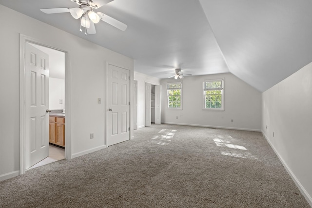 bonus room with light carpet, a ceiling fan, baseboards, and vaulted ceiling