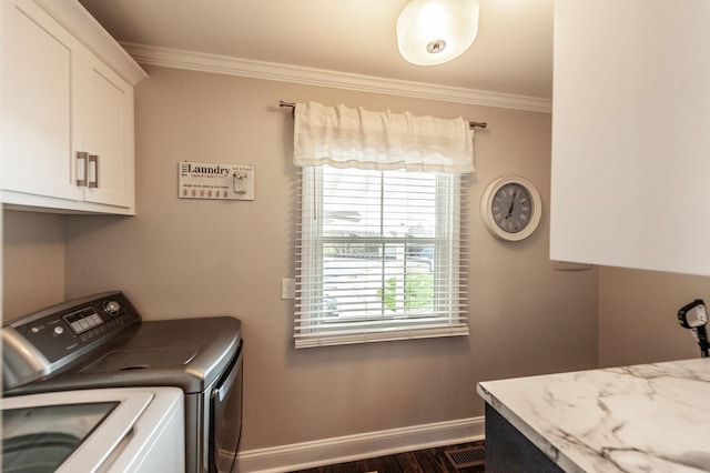 washroom with washer and dryer, cabinet space, ornamental molding, dark wood-style flooring, and baseboards