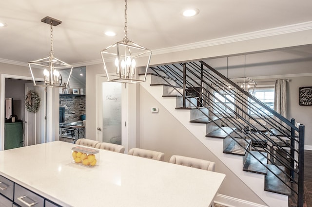 dining room featuring ornamental molding, stairs, a notable chandelier, and baseboards
