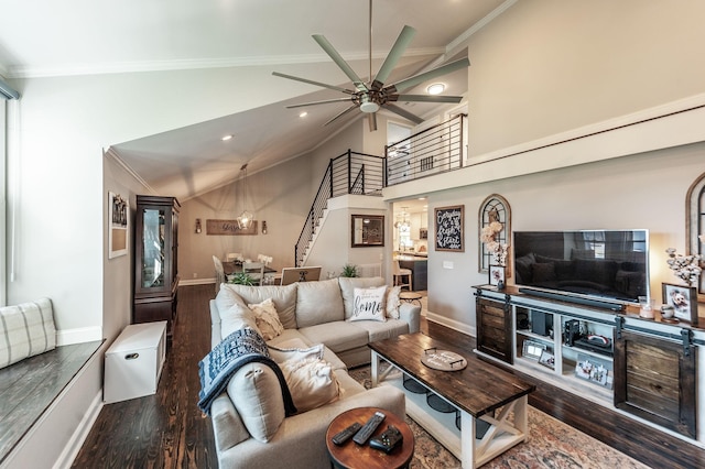 living area featuring wood finished floors, ceiling fan, baseboards, stairway, and crown molding