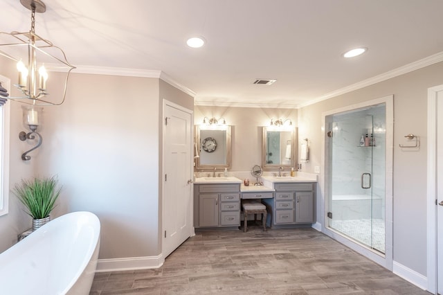 bathroom featuring visible vents, a soaking tub, crown molding, and a stall shower