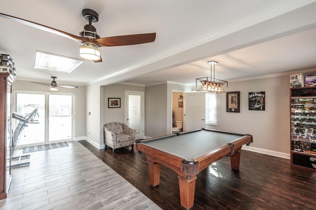 game room with ornamental molding, a ceiling fan, wood finished floors, and baseboards