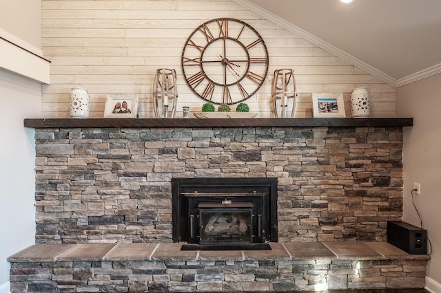 details with baseboards, wooden walls, crown molding, and a fireplace