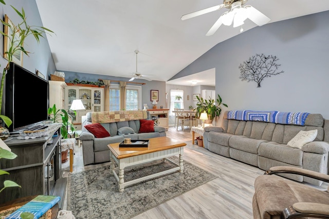 living room featuring a ceiling fan, high vaulted ceiling, and wood finished floors