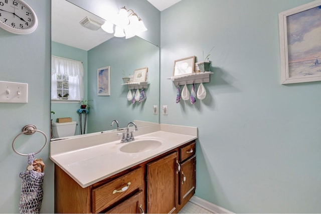 bathroom with baseboards, visible vents, toilet, and vanity