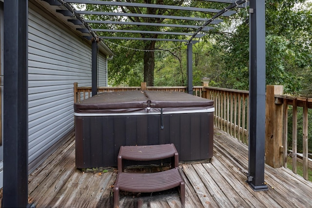 wooden deck with a pergola and a hot tub
