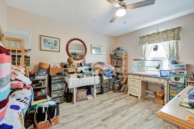 home office with light wood-style flooring and ceiling fan