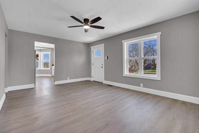 832 Richardson St, Clarksville, TN 37040 - unfurnished living room with plenty of natural light, baseboards, a ceiling fan, and dark wood-style floors
