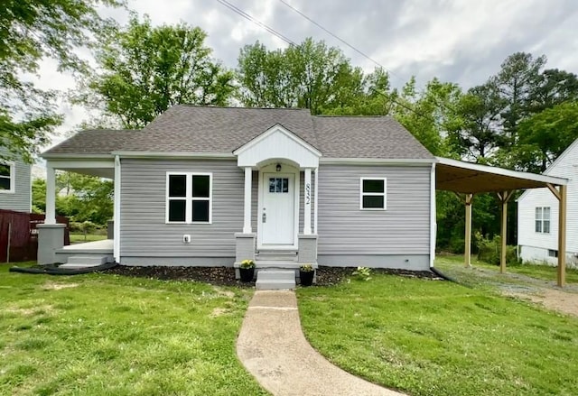 832 Richardson St, Clarksville, TN 37040 - bungalow featuring a carport, a front yard, and a shingled roof