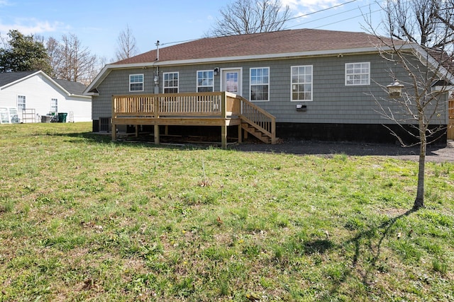 back of property featuring a lawn, central AC unit, roof with shingles, and a deck
