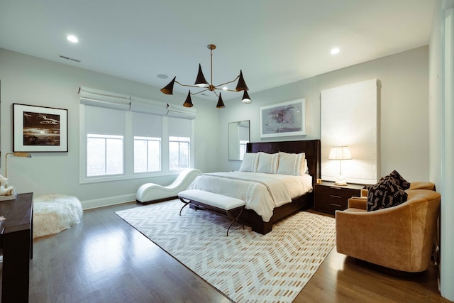 bedroom featuring visible vents, recessed lighting, a chandelier, and wood finished floors