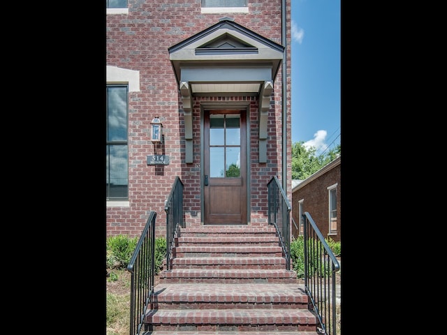property entrance with brick siding