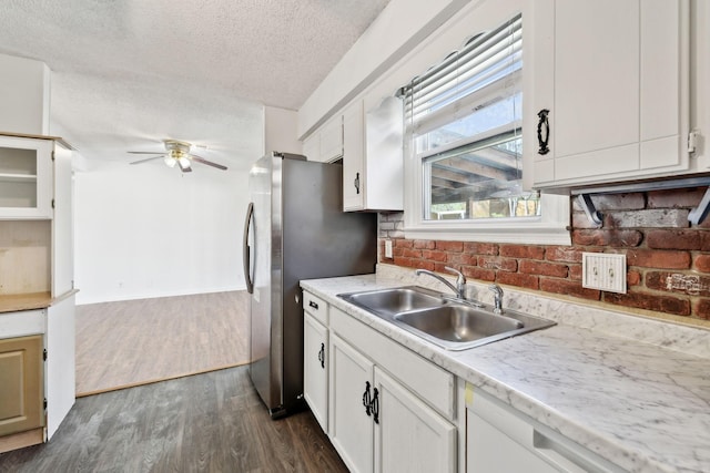 3049 Fieldstone Dr, Antioch, TN 37013 - kitchen with a textured ceiling, light countertops, a ceiling fan, a sink, and dark wood-style floors