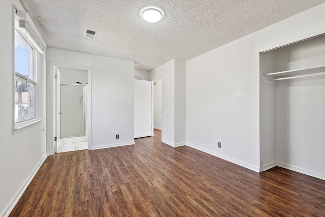3049 Fieldstone Dr, Antioch, TN 37013 - unfurnished bedroom featuring baseboards, a textured ceiling, visible vents, a closet, and wood finished floors