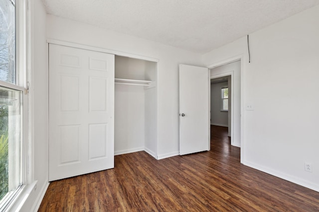 3049 Fieldstone Dr, Antioch, TN 37013 - unfurnished bedroom with a closet, a textured ceiling, baseboards, and dark wood finished floors