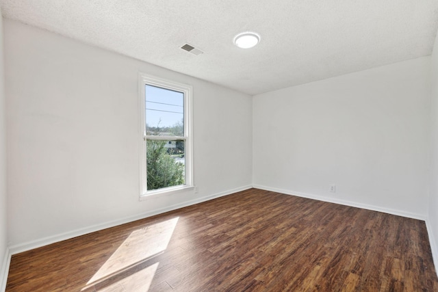 3049 Fieldstone Dr, Antioch, TN 37013 - spare room featuring dark wood-style floors, visible vents, baseboards, and a textured ceiling