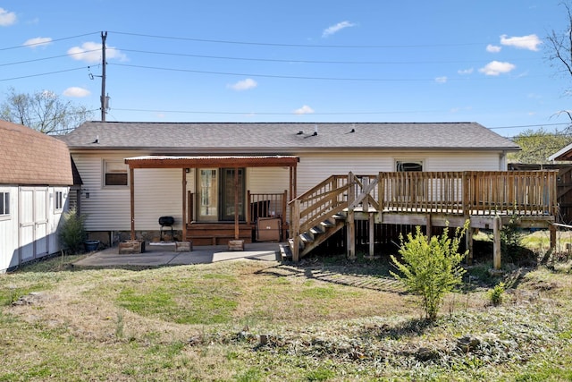 3049 Fieldstone Dr, Antioch, TN 37013 - back of property featuring a lawn, a shingled roof, a deck, and a patio