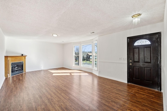 3049 Fieldstone Dr, Antioch, TN 37013 - unfurnished living room featuring a fireplace, wood finished floors, and a textured ceiling