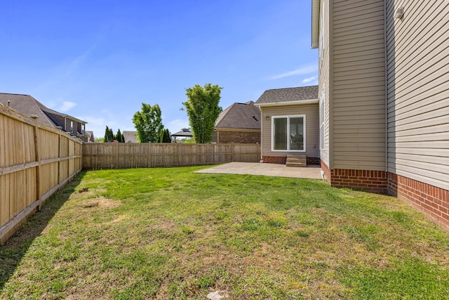view of yard featuring a patio area and a fenced backyard