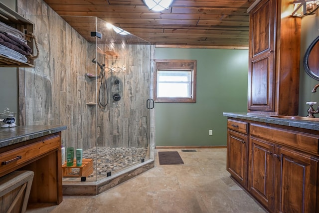 576 Ridgeway Dr, Sugar Tree, TN 38380 - bathroom featuring vanity, stone finish floor, baseboards, wood ceiling, and a stall shower