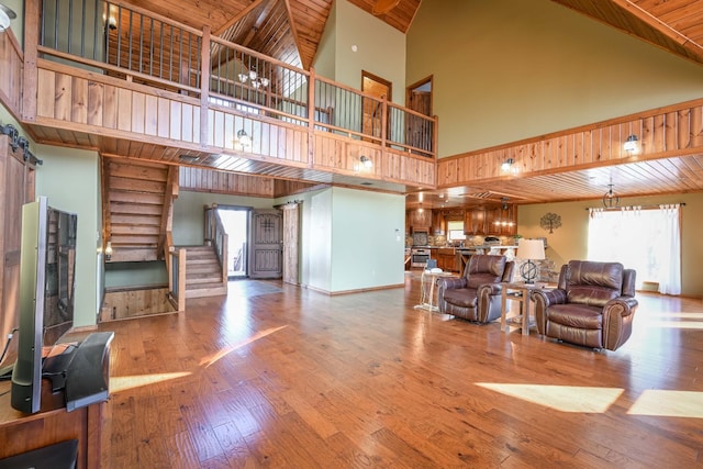 576 Ridgeway Dr, Sugar Tree, TN 38380 - living room with hardwood / wood-style floors, a towering ceiling, stairway, and wooden ceiling