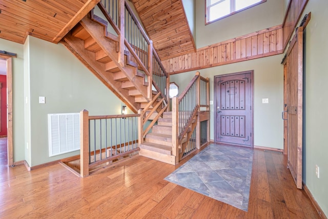 576 Ridgeway Dr, Sugar Tree, TN 38380 - entryway with visible vents, hardwood / wood-style flooring, baseboards, a towering ceiling, and wooden ceiling