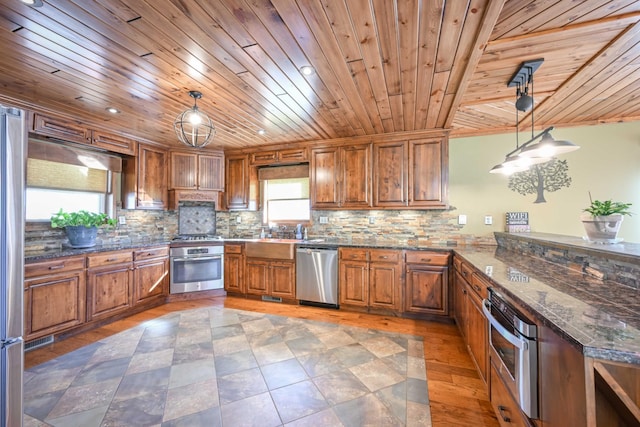 576 Ridgeway Dr, Sugar Tree, TN 38380 - kitchen featuring stainless steel appliances, brown cabinetry, and tasteful backsplash