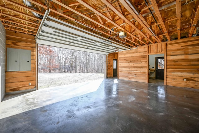 576 Ridgeway Dr, Sugar Tree, TN 38380 - garage featuring wood walls, a garage door opener, and electric panel