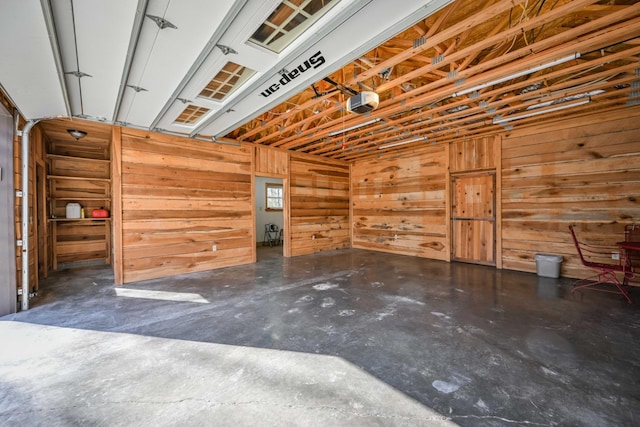 576 Ridgeway Dr, Sugar Tree, TN 38380 - garage featuring a garage door opener and wooden walls
