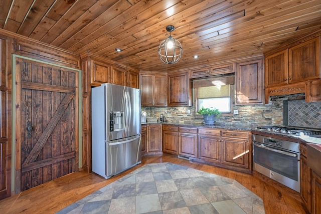 576 Ridgeway Dr, Sugar Tree, TN 38380 - kitchen featuring light wood-style flooring, brown cabinetry, tasteful backsplash, and stainless steel appliances