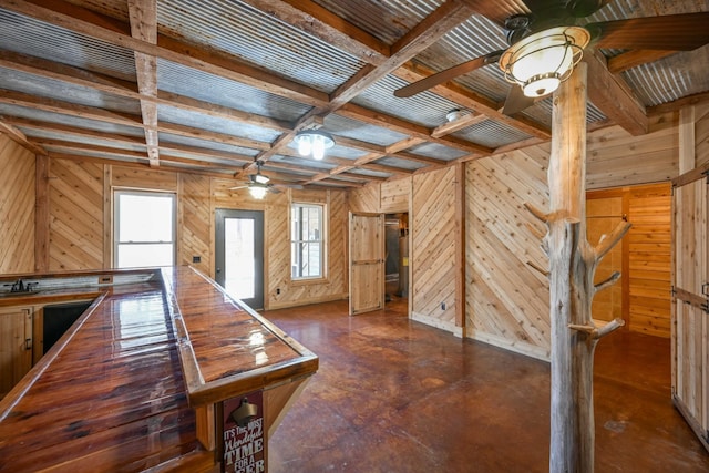 576 Ridgeway Dr, Sugar Tree, TN 38380 - interior space featuring coffered ceiling, a ceiling fan, wood walls, finished concrete floors, and beamed ceiling