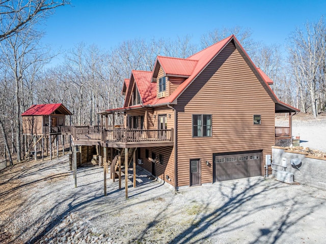 576 Ridgeway Dr, Sugar Tree, TN 38380 - view of home's exterior with driveway, a deck, and an attached garage