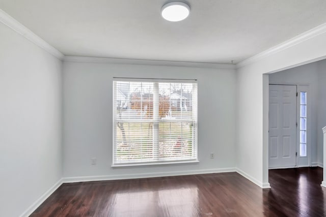 unfurnished room with plenty of natural light, baseboards, and wood finished floors