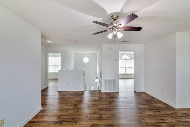 interior space with visible vents, a ceiling fan, and wood finished floors