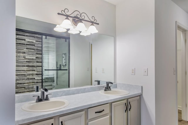 bathroom featuring double vanity, a sink, and a chandelier