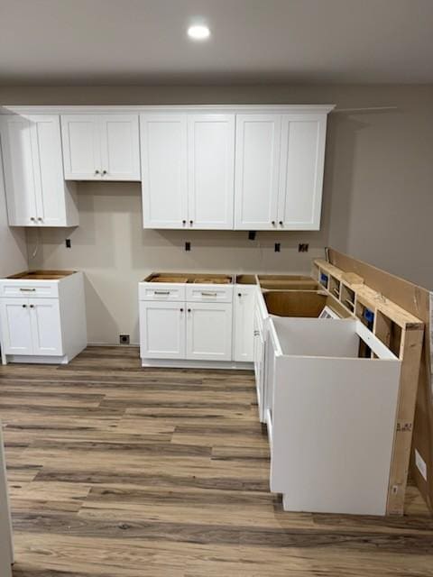 clothes washing area featuring recessed lighting and wood finished floors