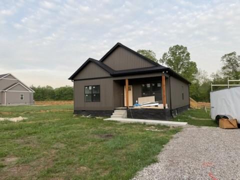 back of property featuring a yard