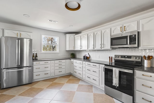 234 Spring St, La Vergne, TN 37086 - kitchen featuring visible vents, decorative backsplash, white cabinetry, and appliances with stainless steel finishes