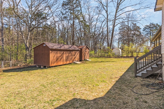 234 Spring St, La Vergne, TN 37086 - view of yard with fence, a storage unit, an outbuilding, and stairway
