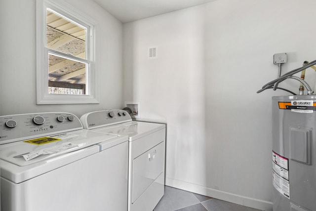 234 Spring St, La Vergne, TN 37086 - clothes washing area featuring laundry area, visible vents, baseboards, washing machine and clothes dryer, and water heater
