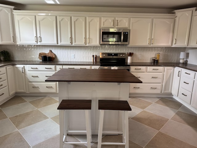 234 Spring St, La Vergne, TN 37086 - kitchen featuring decorative backsplash, appliances with stainless steel finishes, and butcher block counters