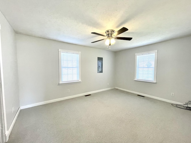 1088 Poole Mill Rd, Crofton, KY 42217 - carpeted spare room featuring baseboards, a textured ceiling, visible vents, a ceiling fan, and electric panel