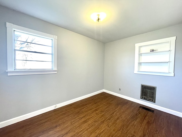 1088 Poole Mill Rd, Crofton, KY 42217 - spare room featuring visible vents, baseboards, wood finished floors, built in features, and heating unit