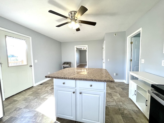 1088 Poole Mill Rd, Crofton, KY 42217 - kitchen featuring baseboards, white cabinets, ceiling fan, and a kitchen island
