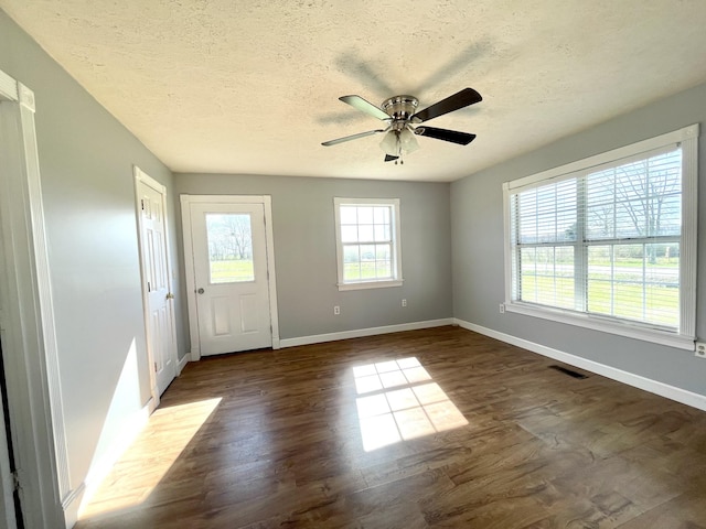 1088 Poole Mill Rd, Crofton, KY 42217 - interior space with a textured ceiling, dark wood-style floors, baseboards, visible vents, and ceiling fan