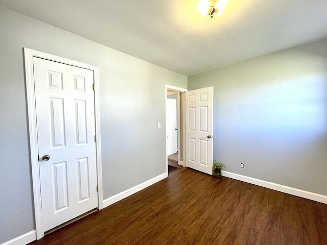 1088 Poole Mill Rd, Crofton, KY 42217 - unfurnished bedroom with baseboards and dark wood finished floors